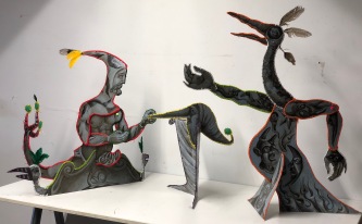 "The Siren & the Machiavels" 2018 Recycled cardboard, acrylic paint, embroidery floss, reclaimed feathers. Each figure approx: 26 by 32 inches.