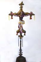 The Anchorite's Crucifix 2019 Mixed media: acrylic painted canvas, recycled fabric, beads, bells, embroidery floss, black-pipe interior structure, poly-fil, discarded furniture and metal work Crucifix: 60 by 32 by 10 inches; total installation varies upon situation.